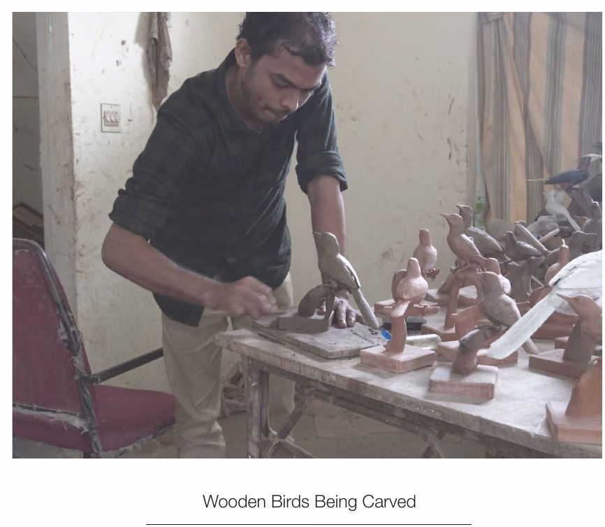 Wooden birds being carved at a bench, from the documentary on vernacular designers