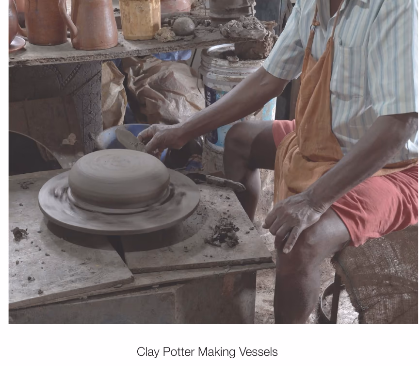 A clay potter throwing a vessel on the wheel, from the documentary on vernacular designers