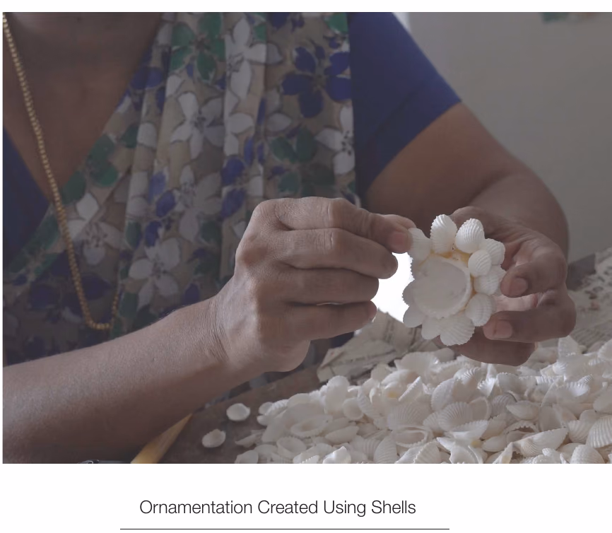 Ornamentation being assembled by hand out of shells, from the documentary on vernacular designers